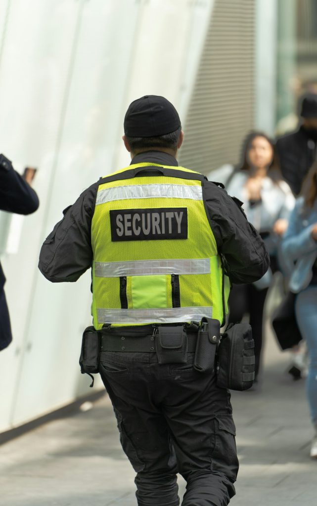 a-security-officer-walking-down-a-street-d6rtxw4hai